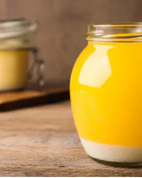 Golden ghee in a traditional glass jar