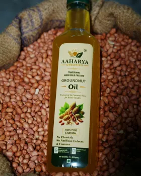 Aaharya Groundnut Oil bottle on raw groundnuts